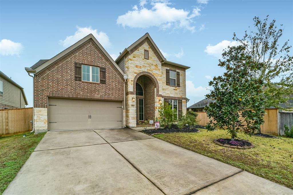 This charming two-story home features a blend of brick and stone exterior, a spacious two-car tandem garage, and a well-maintained front yard with mature landscaping. Perfect for families seeking a welcoming neighborhood.