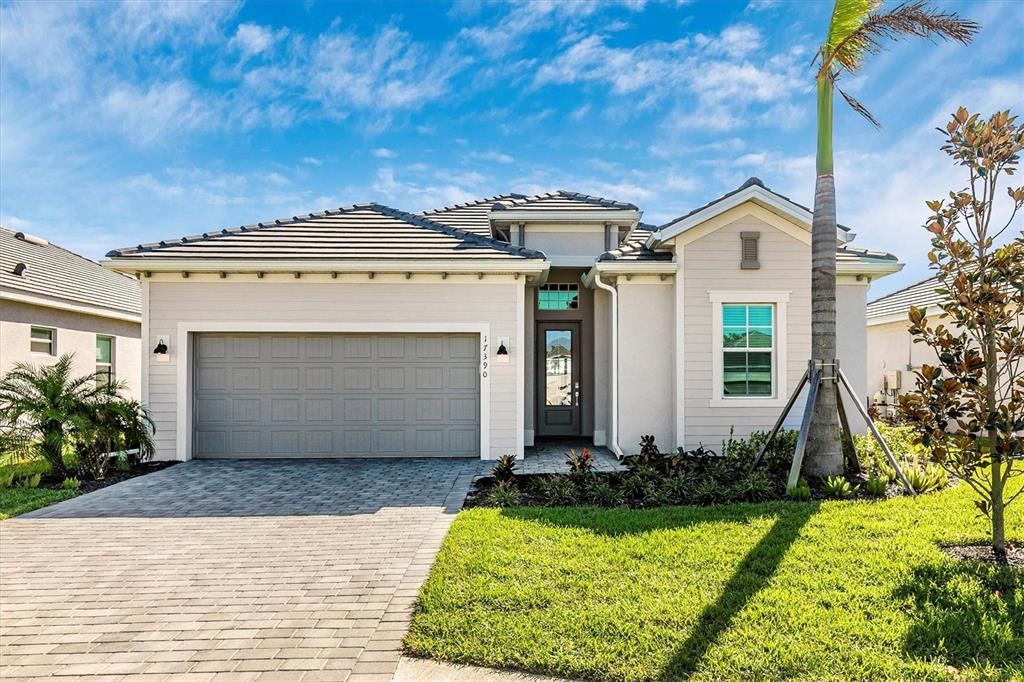 a front view of a house with a yard and garage