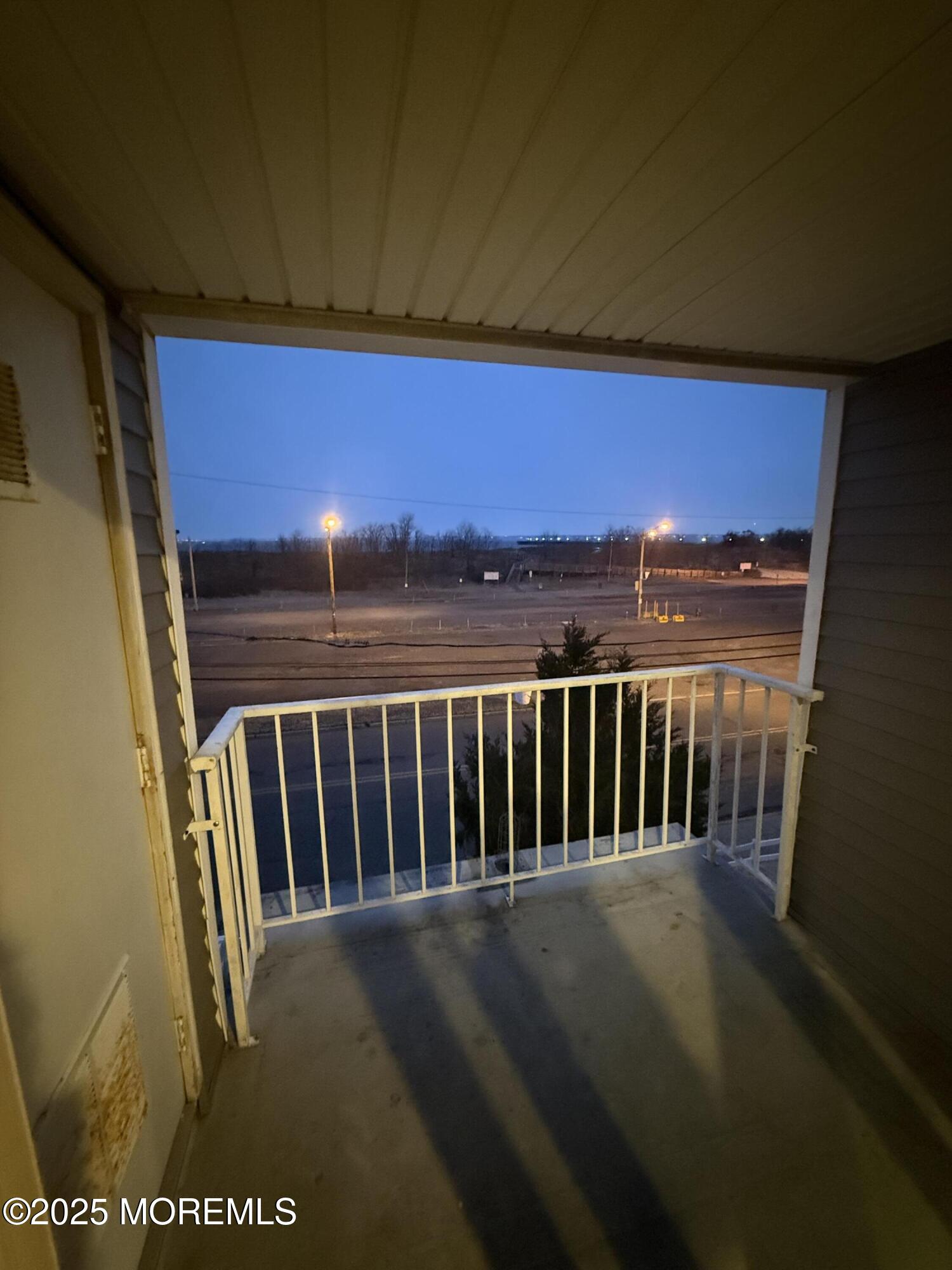 a view of balcony with wooden floor