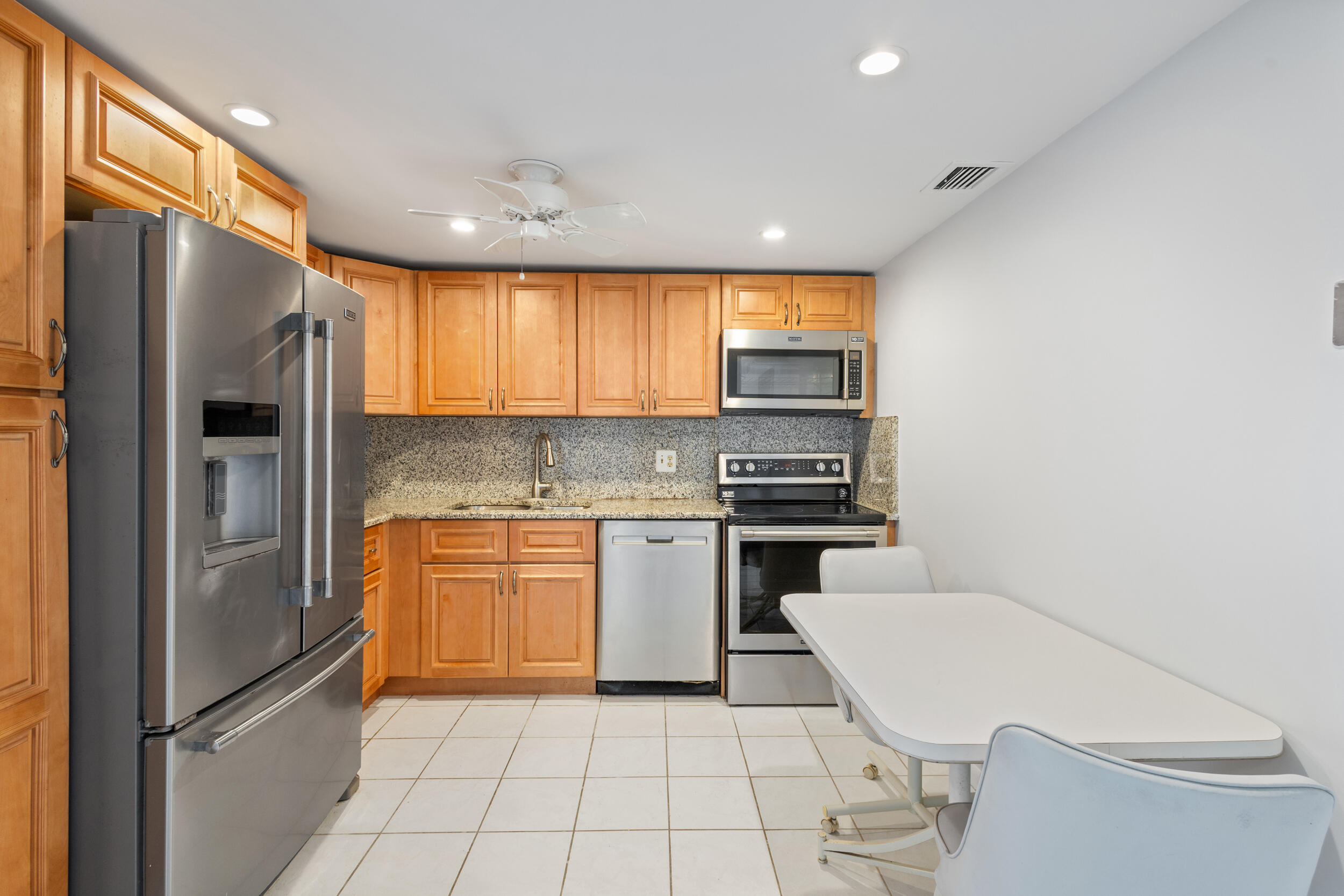 a kitchen with a refrigerator a sink and a stove