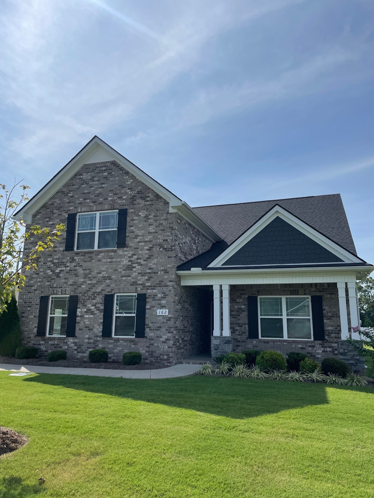 a front view of a house with a garden