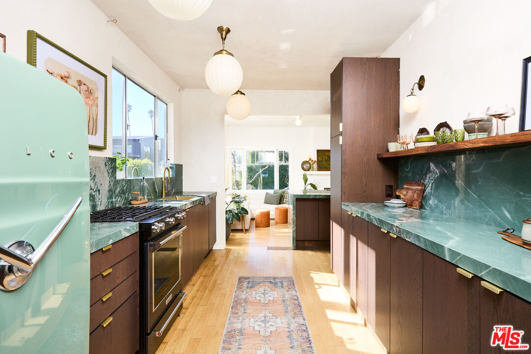 a kitchen with stainless steel appliances granite countertop a stove and a refrigerator