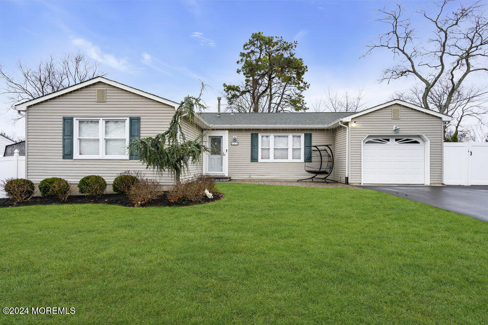 a front view of a house with a garden and yard