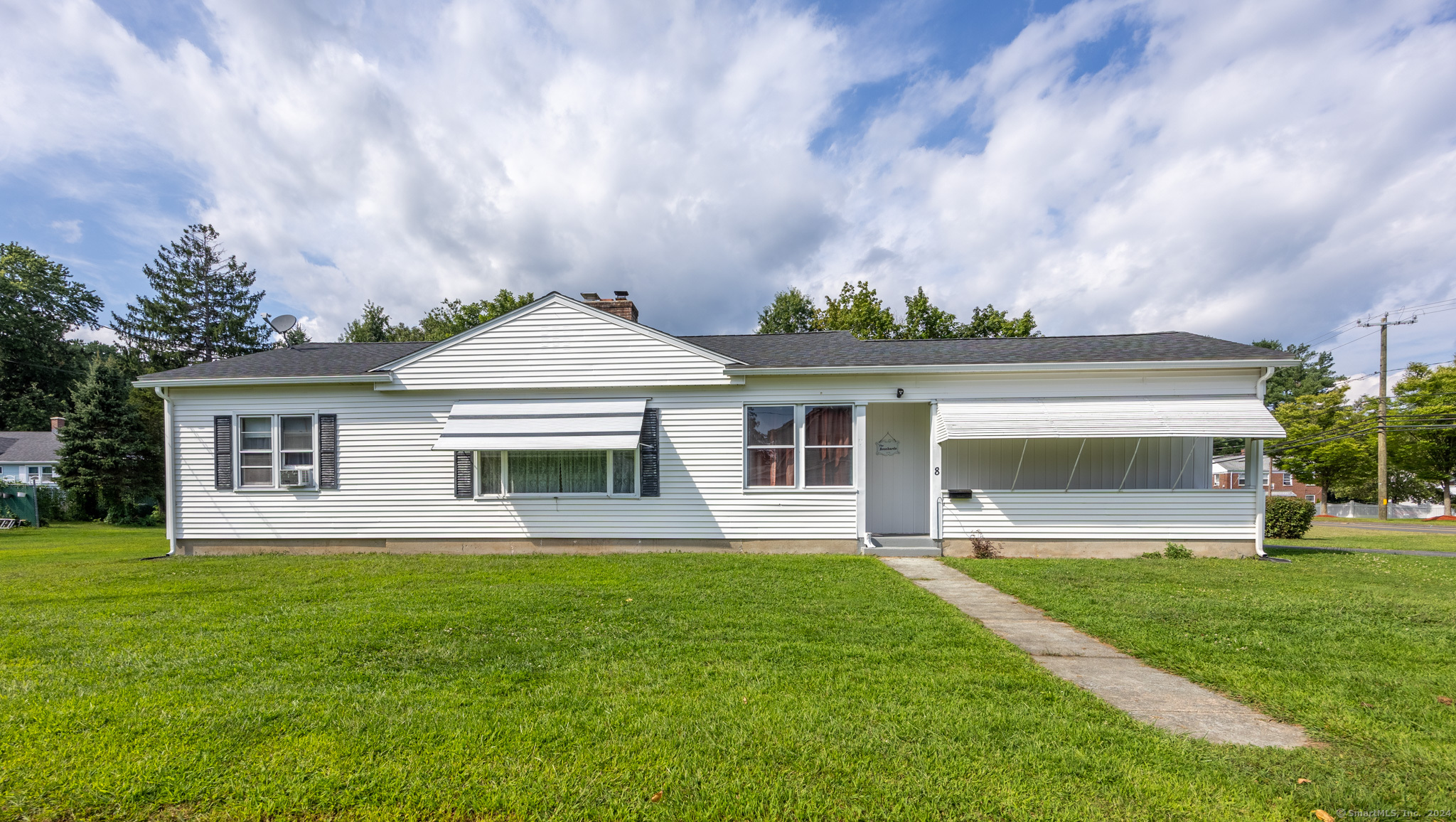 a front view of house with yard and green space