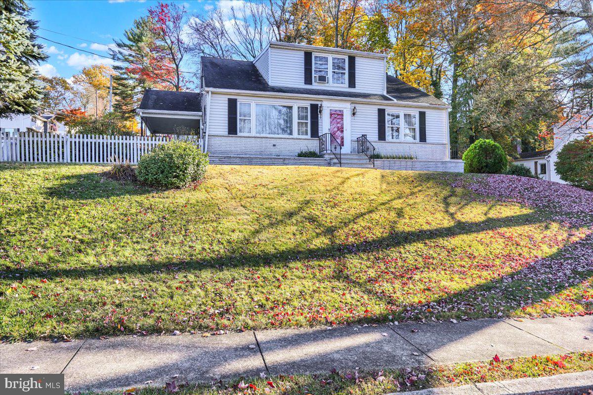 a view of a house with a yard covered with snow in the background