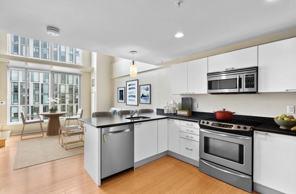 a kitchen with stainless steel appliances granite countertop a stove and a sink