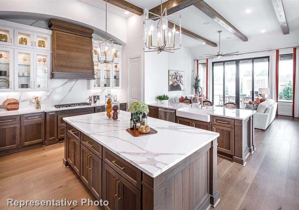 a kitchen with stainless steel appliances granite countertop a sink stove and wooden floor