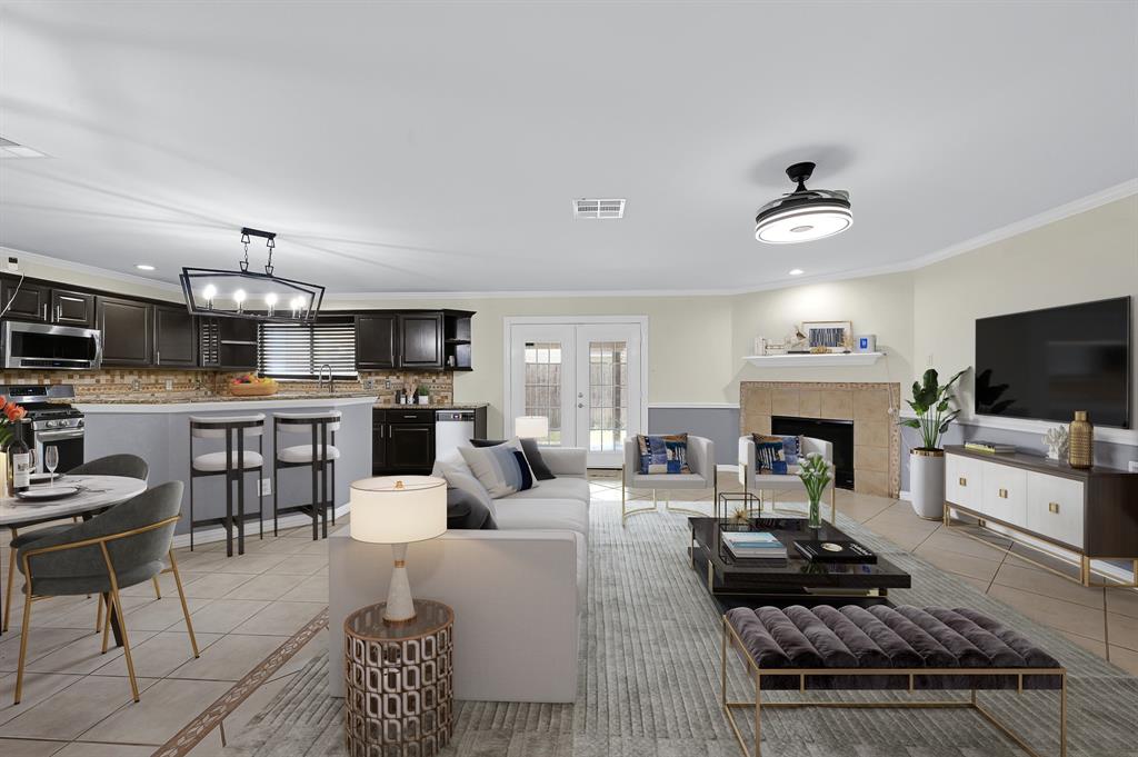 a living room with furniture a fireplace and a flat screen tv