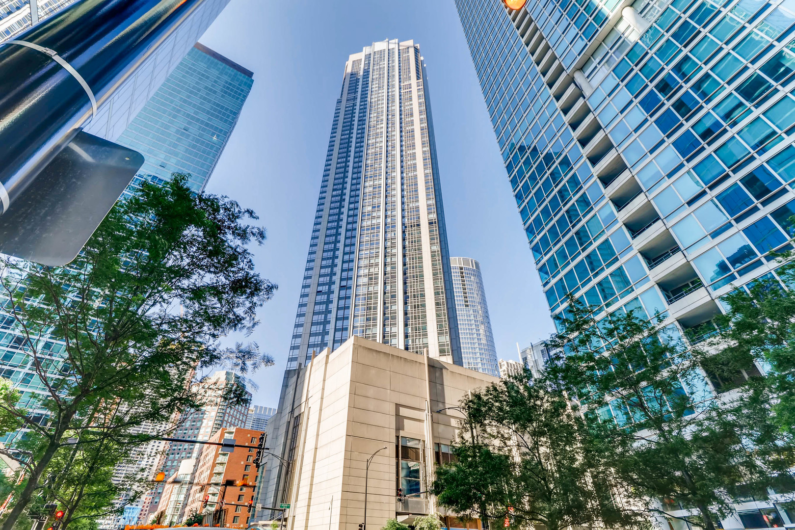 a front view of a multi story building with yard