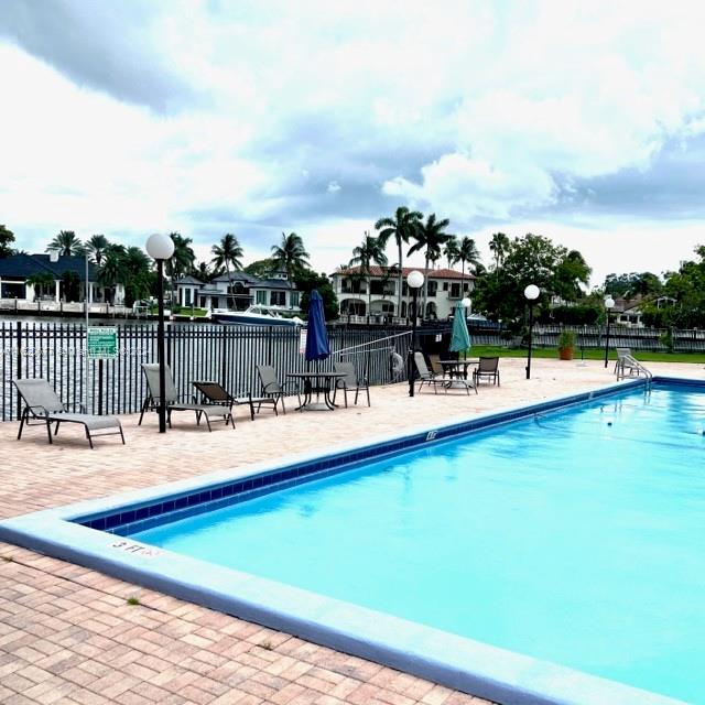 a view of a swimming pool with an outdoor seating