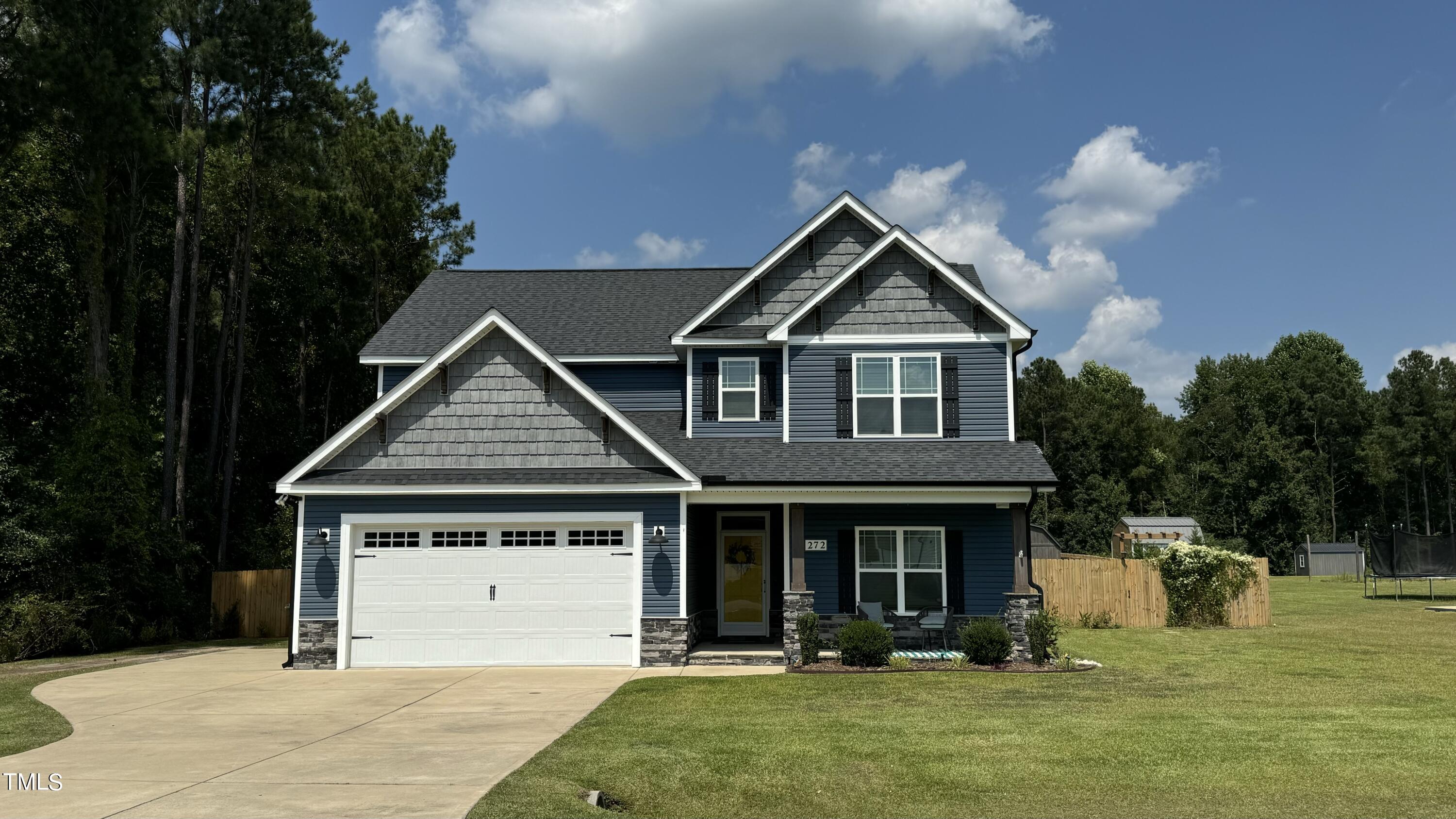 a front view of a house with a yard balcony and outdoor seating