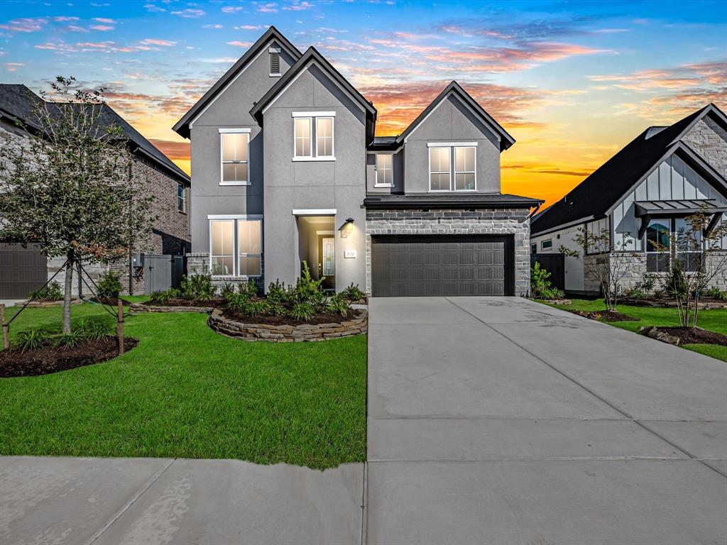 a front view of a house with a yard and garage