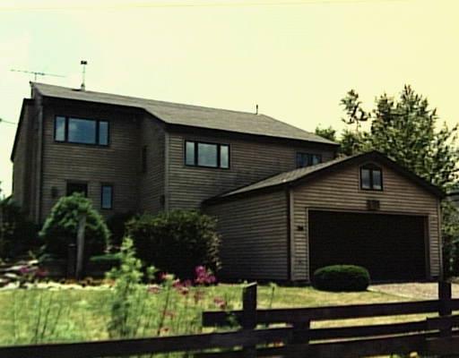 a front view of a house with plants