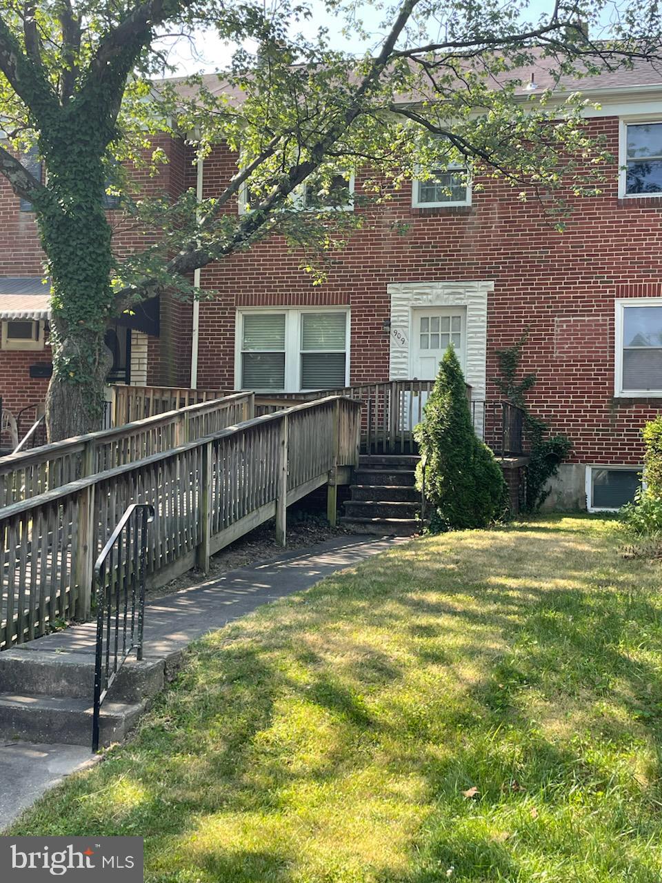 a view of a house with a yard and sitting area