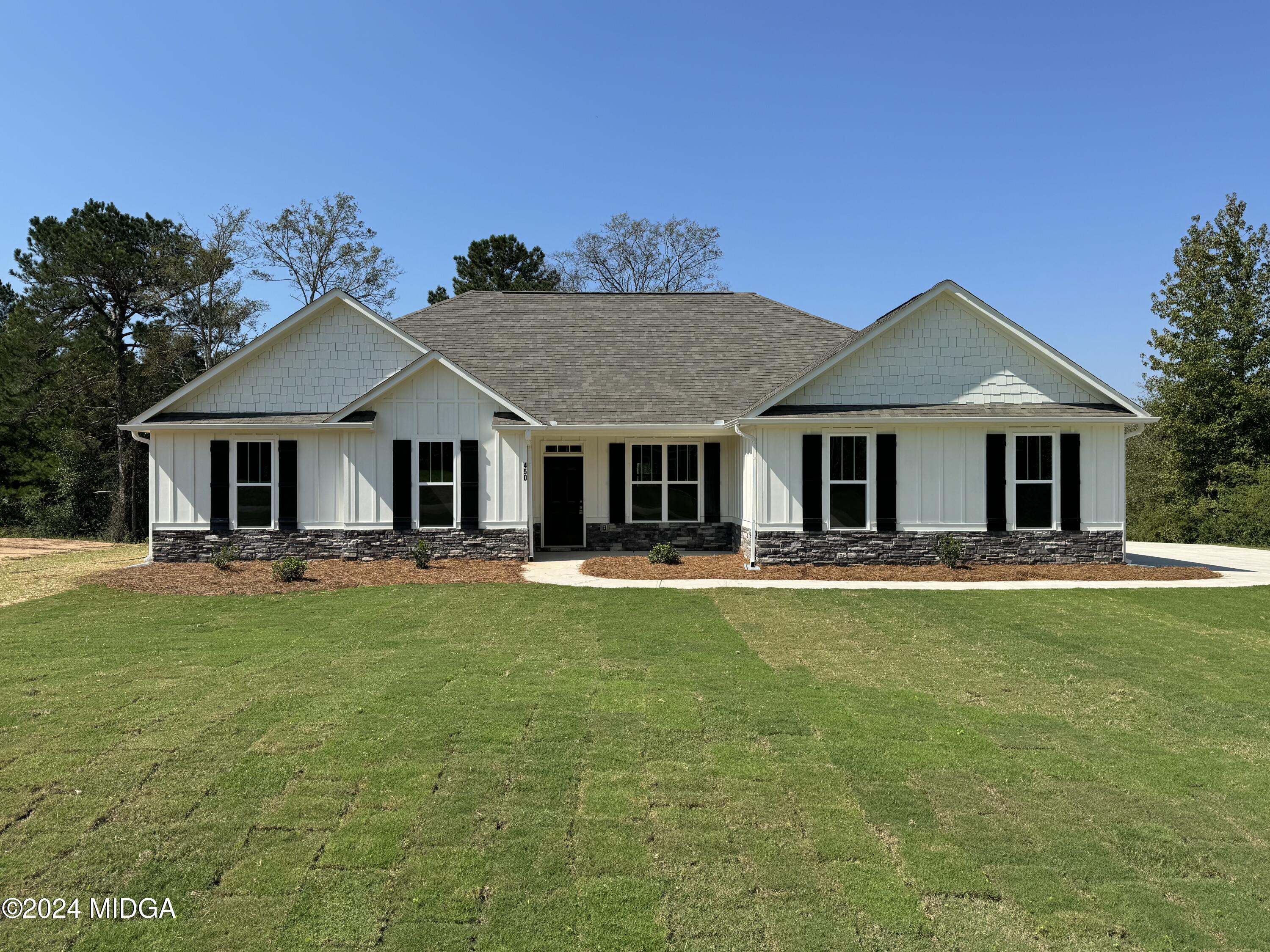 a front view of a house with swimming pool having outdoor seating