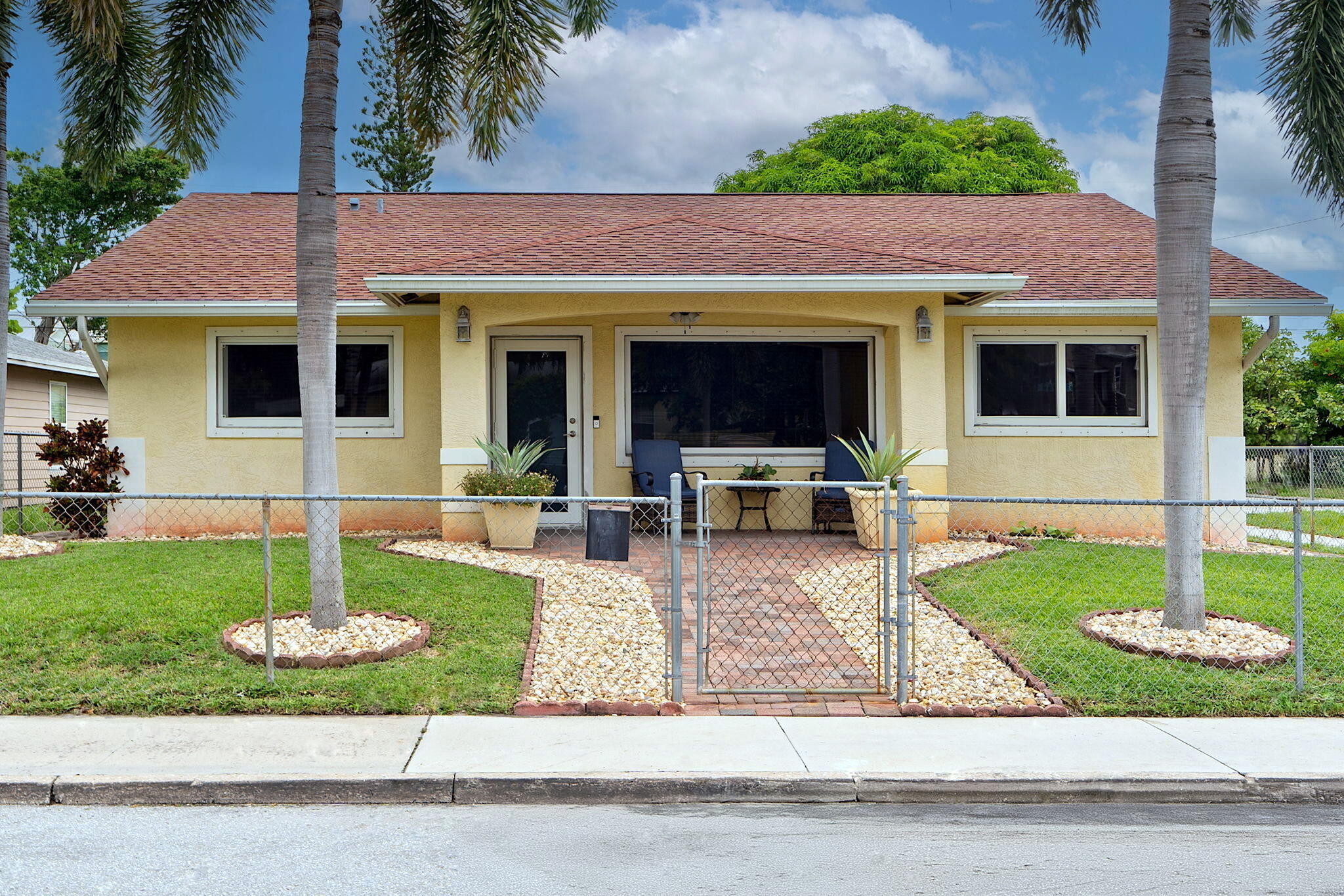 a front view of a house with garden