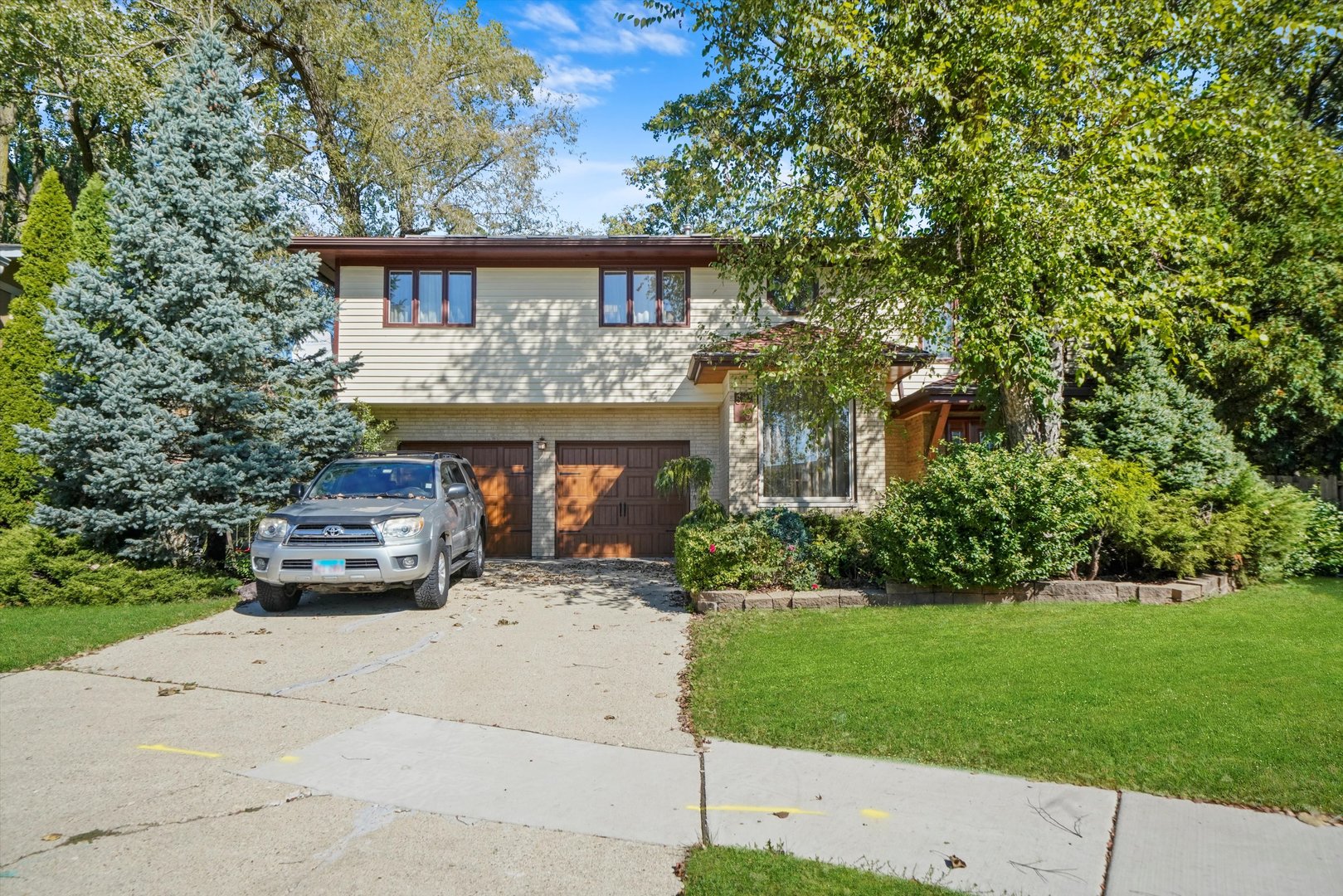 a car parked in front of a house with a small yard