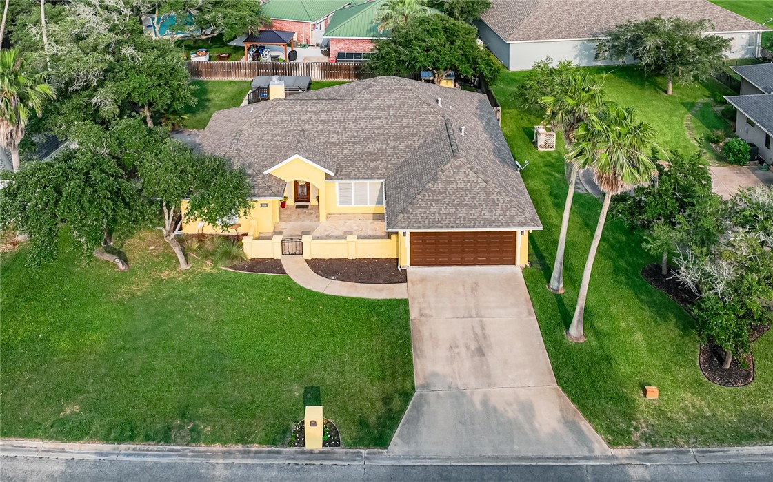 an aerial view of a house with a yard