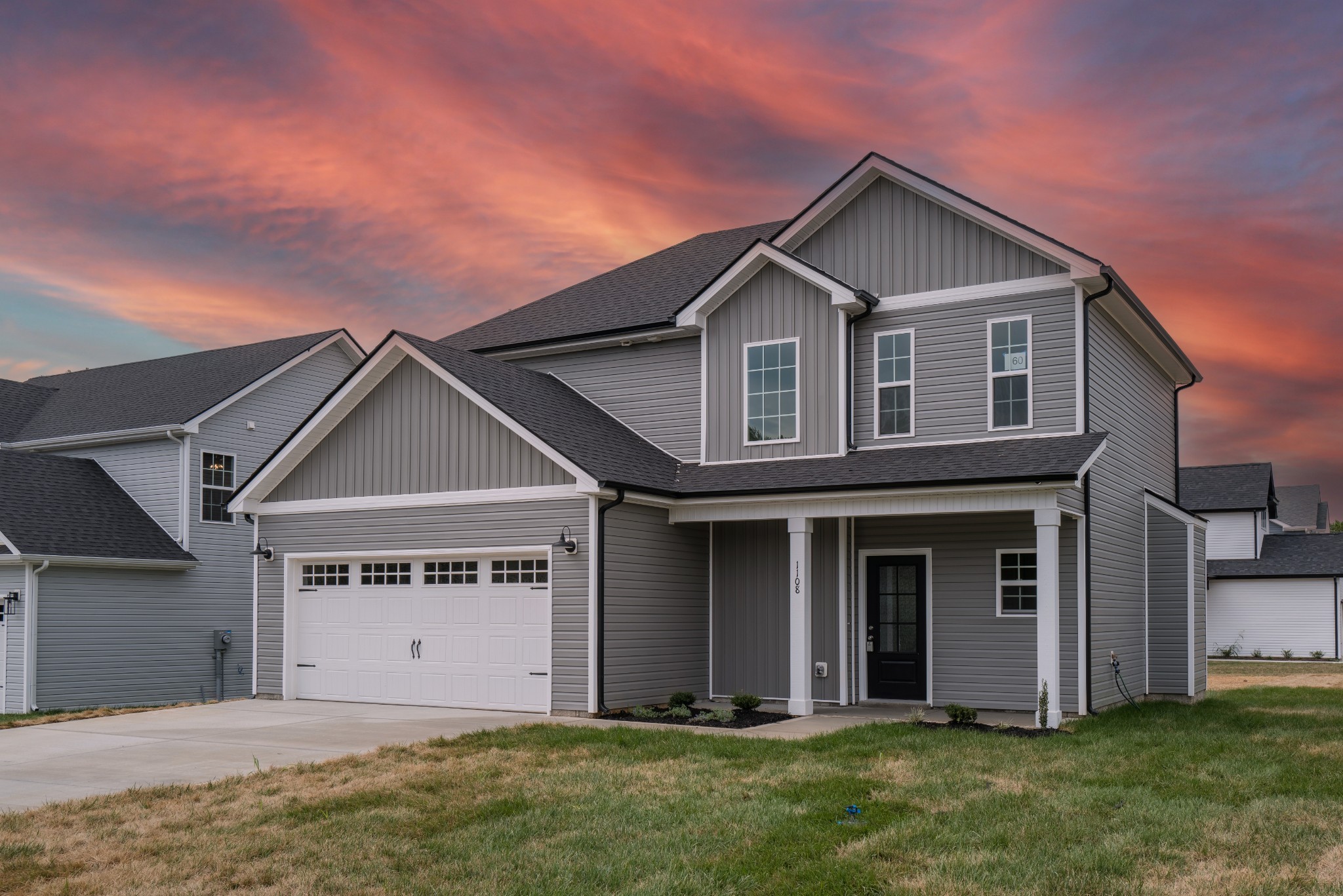 a front view of a house with a yard and garage