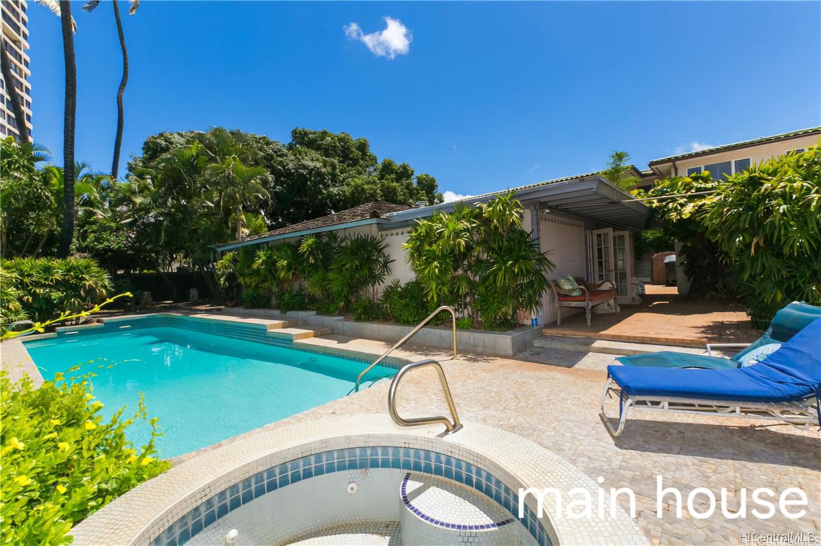 a swimming pool with outdoor seating and yard