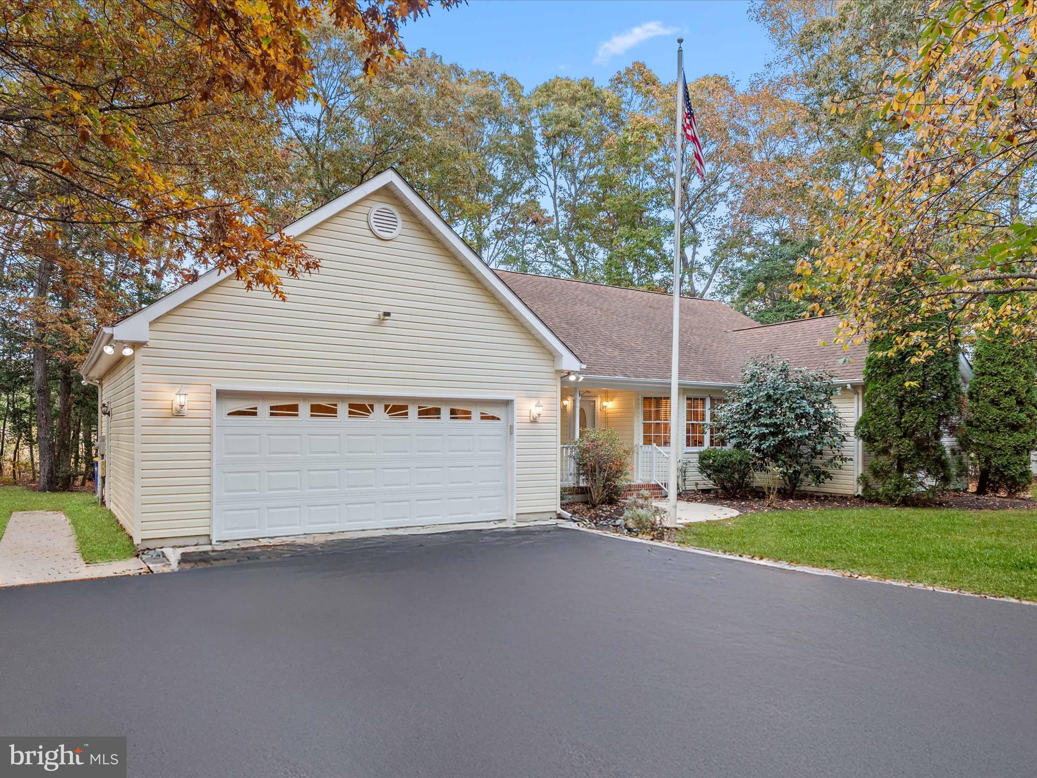 a view of a house with a yard and garage