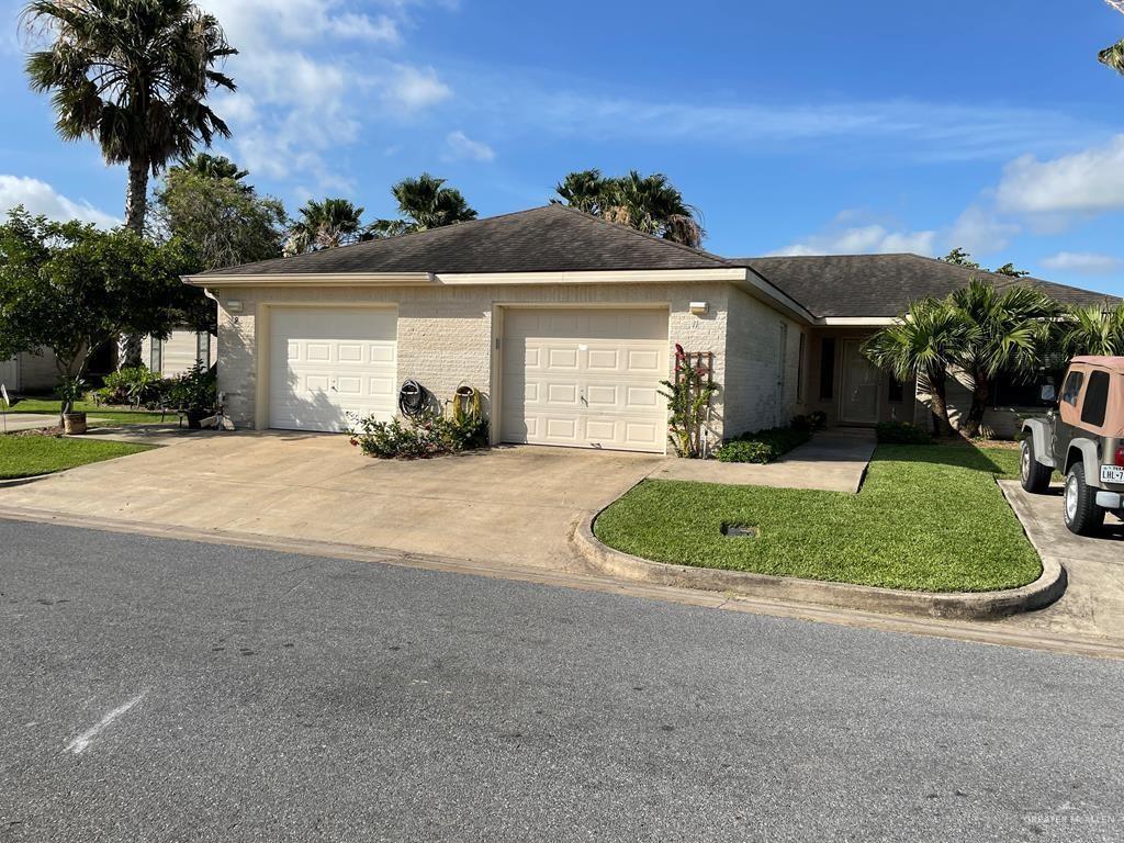 Single story home featuring a garage and a front yard