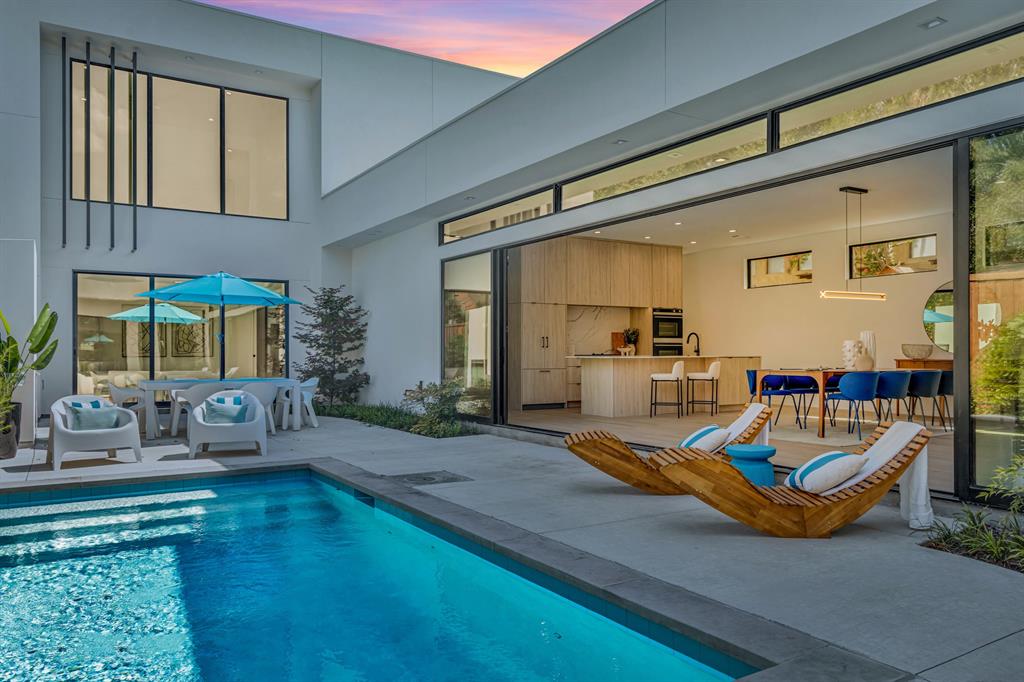 a living room with furniture pool table and chairs