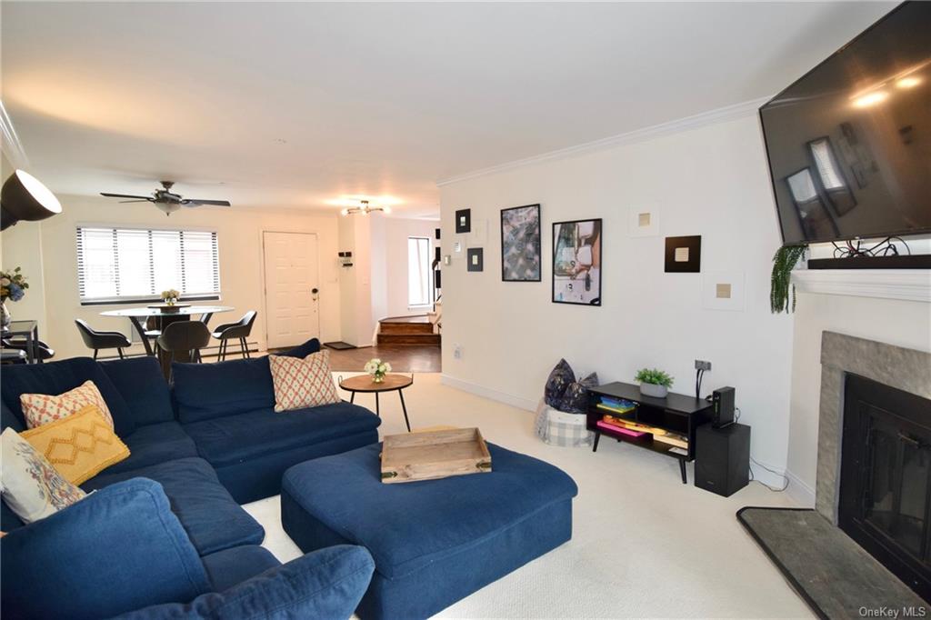 a living room with furniture fireplace and flat screen tv