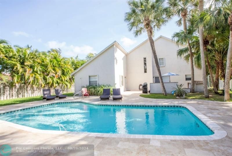 a view of a house with swimming pool and sitting area