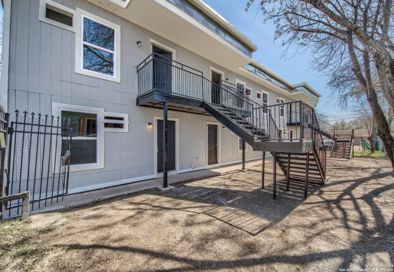 a view of a house with a wooden deck