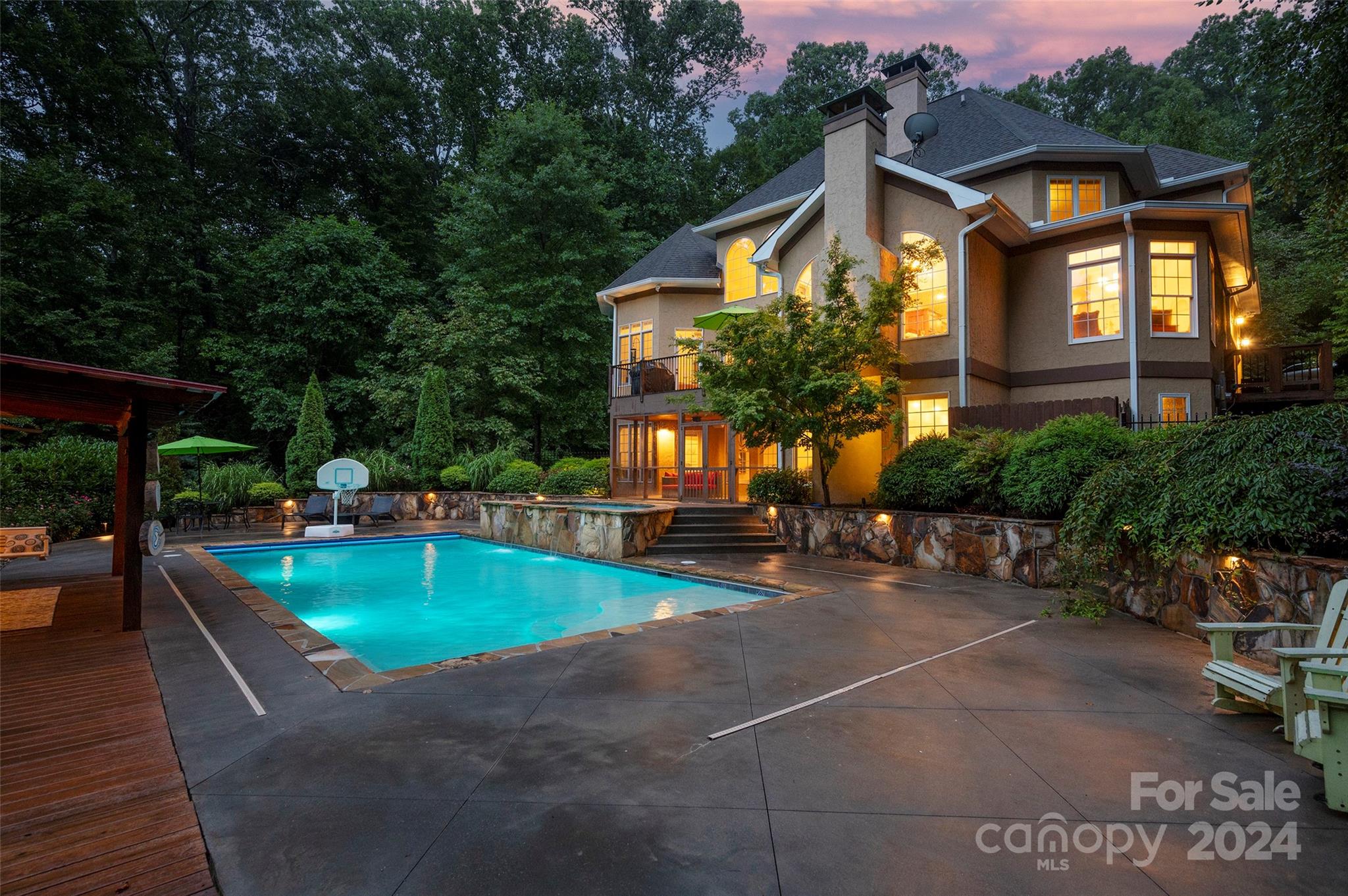 a front view of a house with swimming pool garden and patio