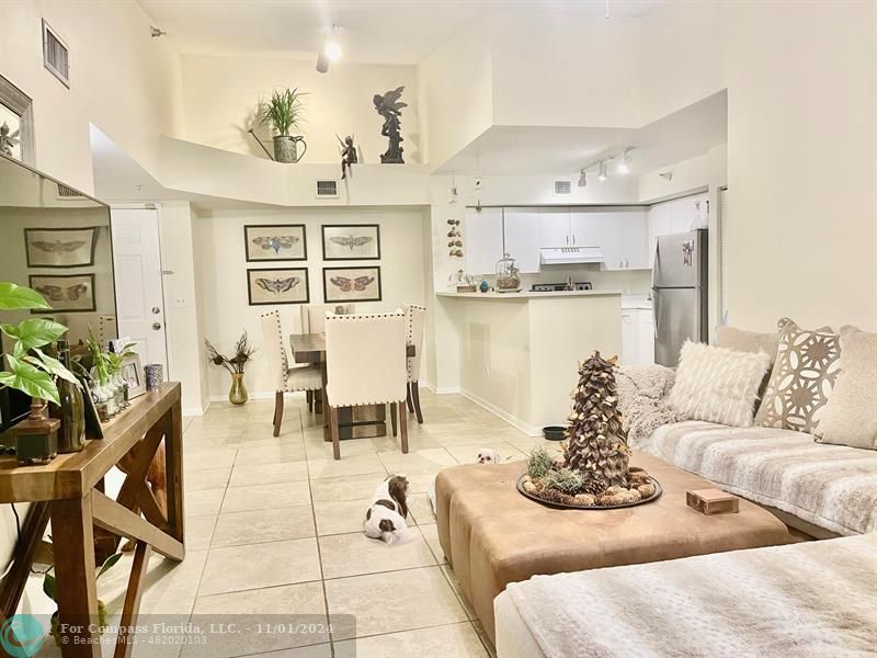 a living room with furniture and kitchen view