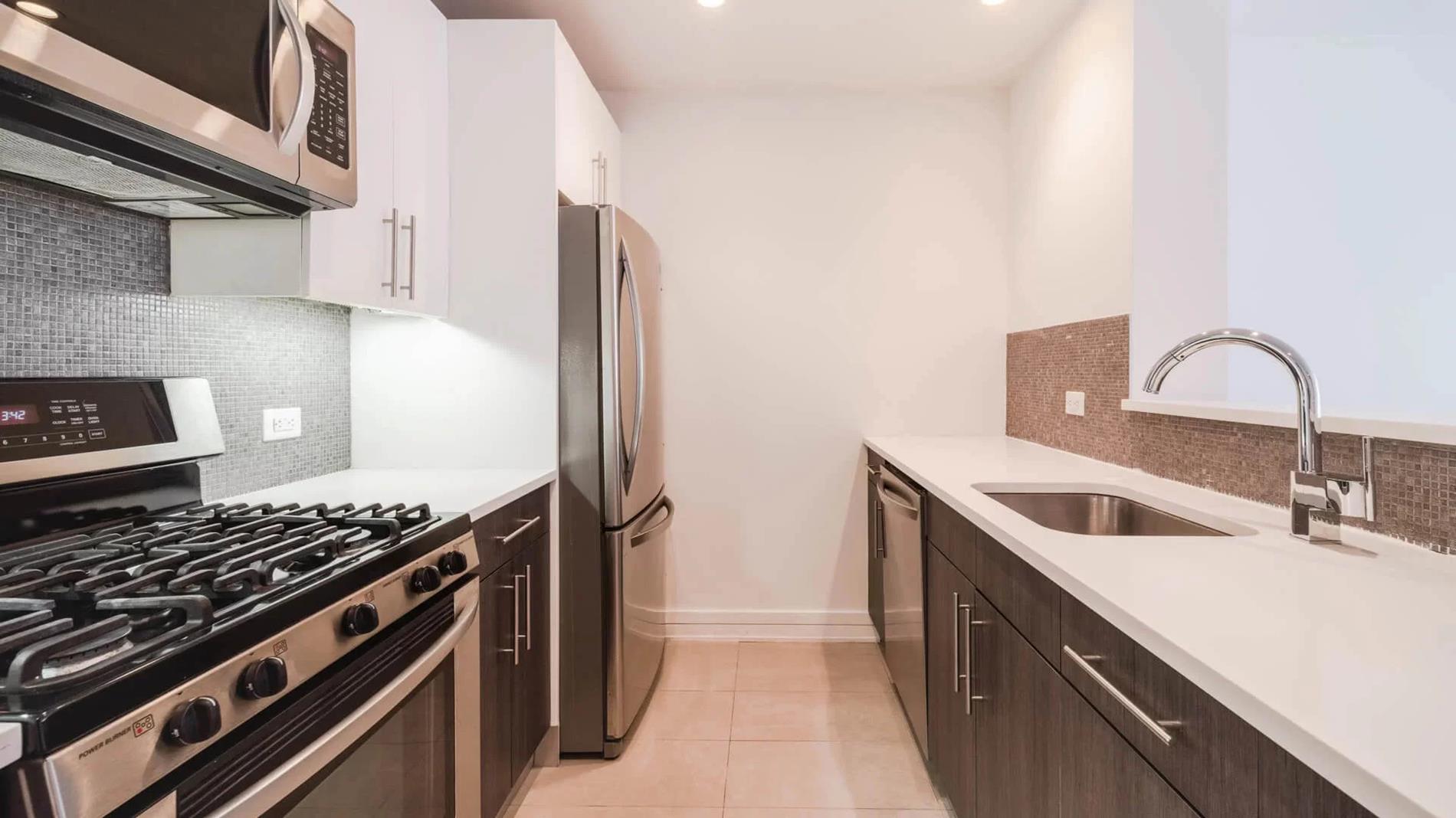 a kitchen with sink a stove and cabinets