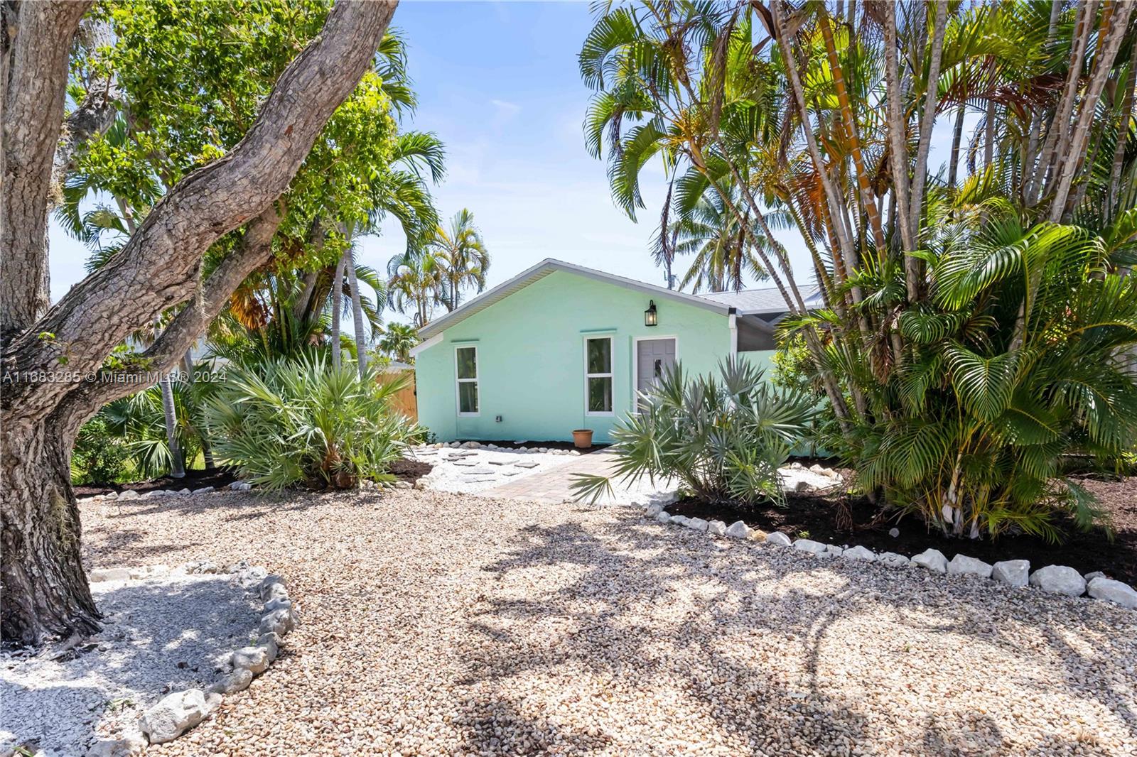 a view of a house with a tree in the background