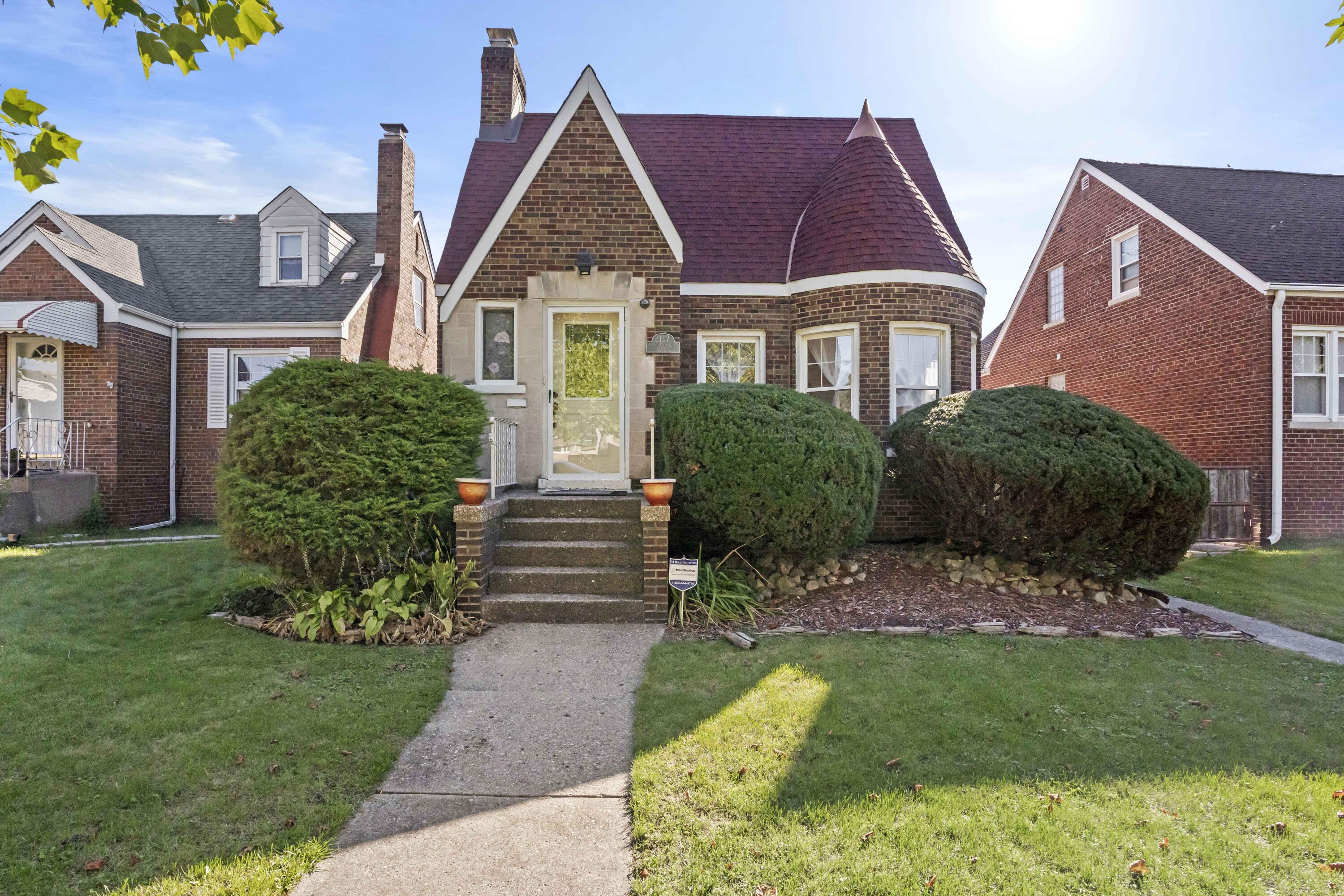 a front view of a house with a garden