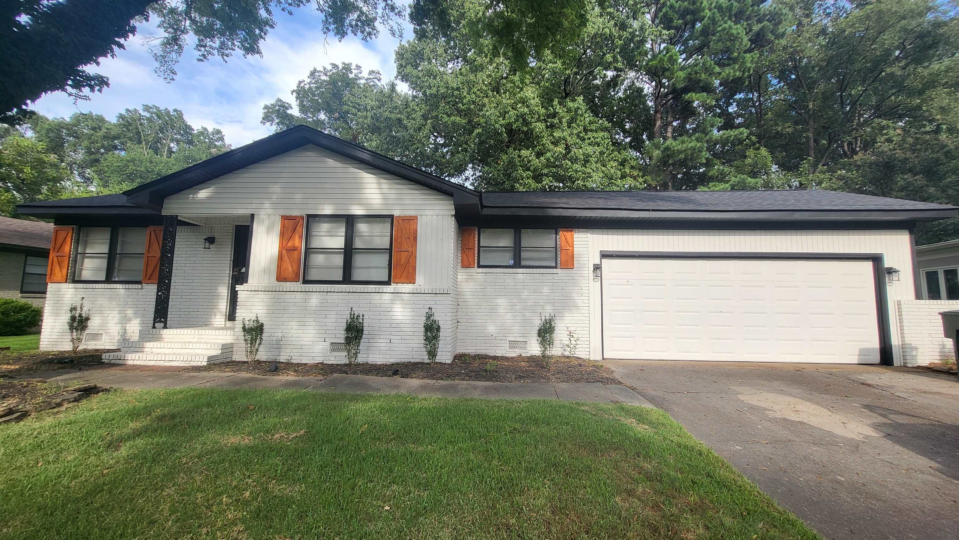 Ranch-style house with a garage and a front yard