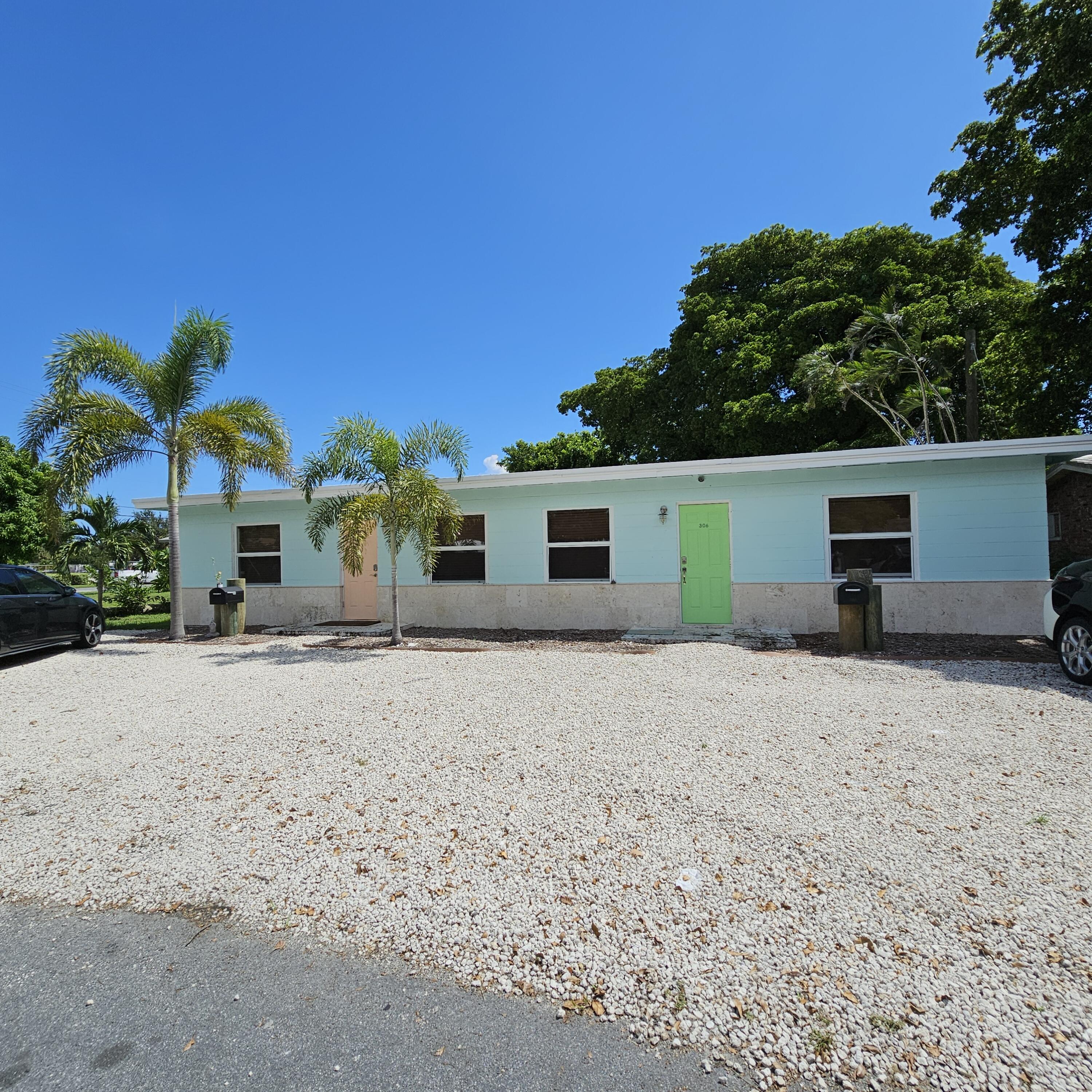 a front view of a house with a yard and a garage