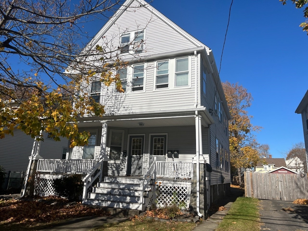 a front view of a house with sitting area