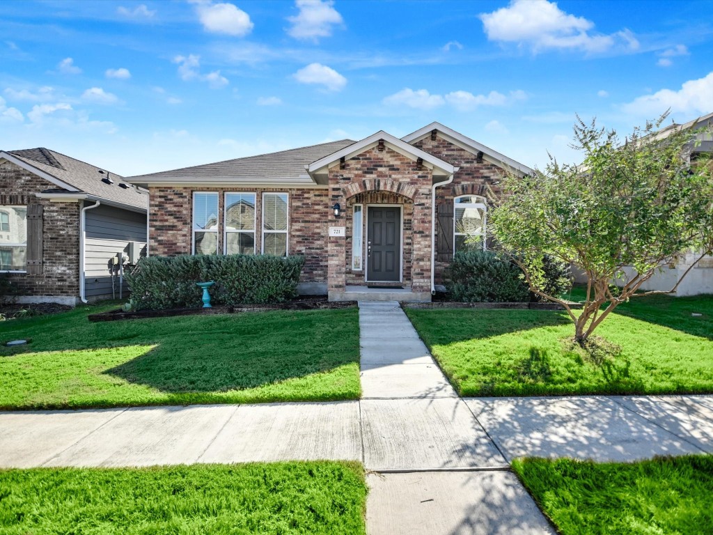 a front view of a house with a yard