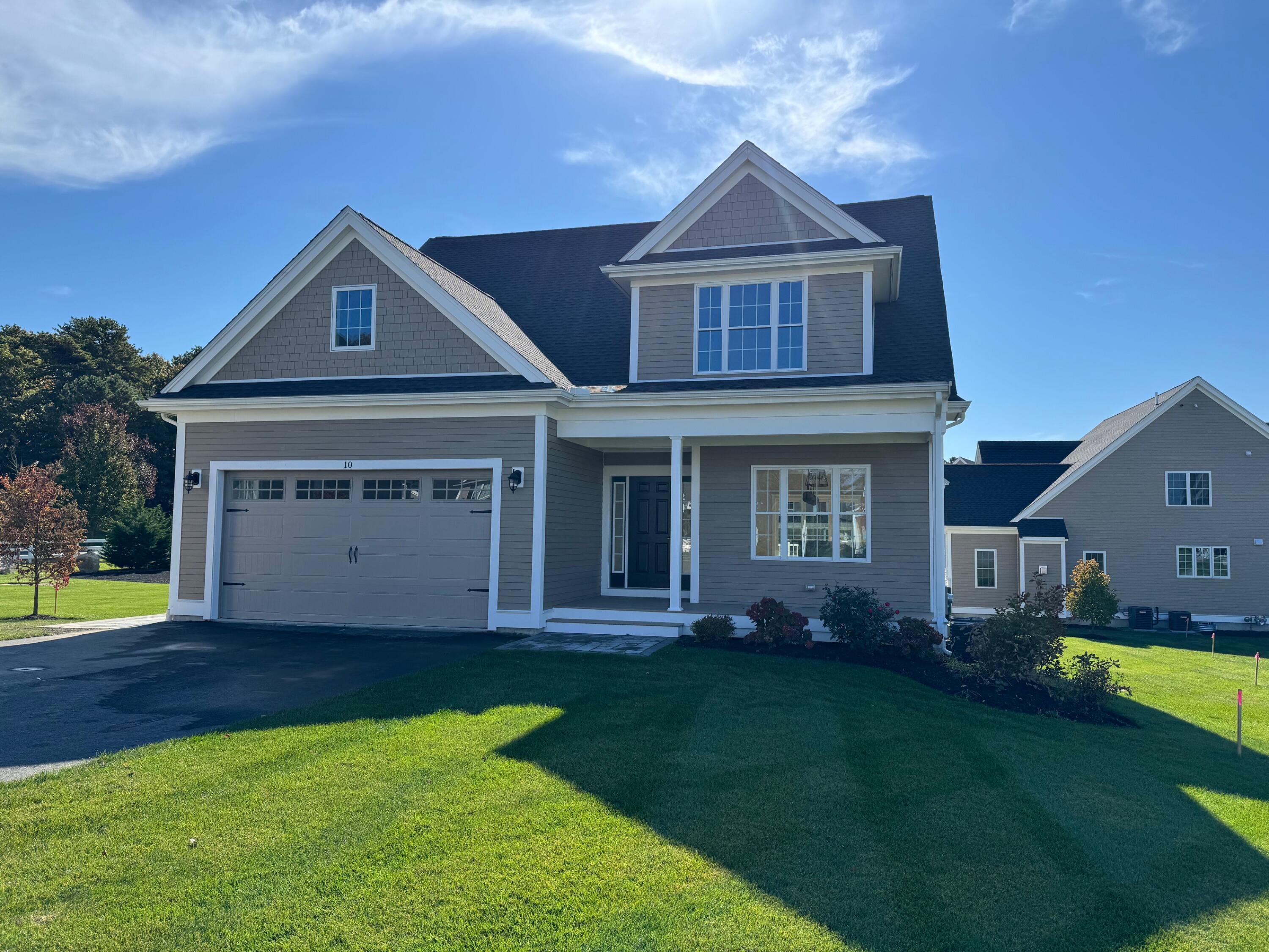 a front view of a house with a garden and deck