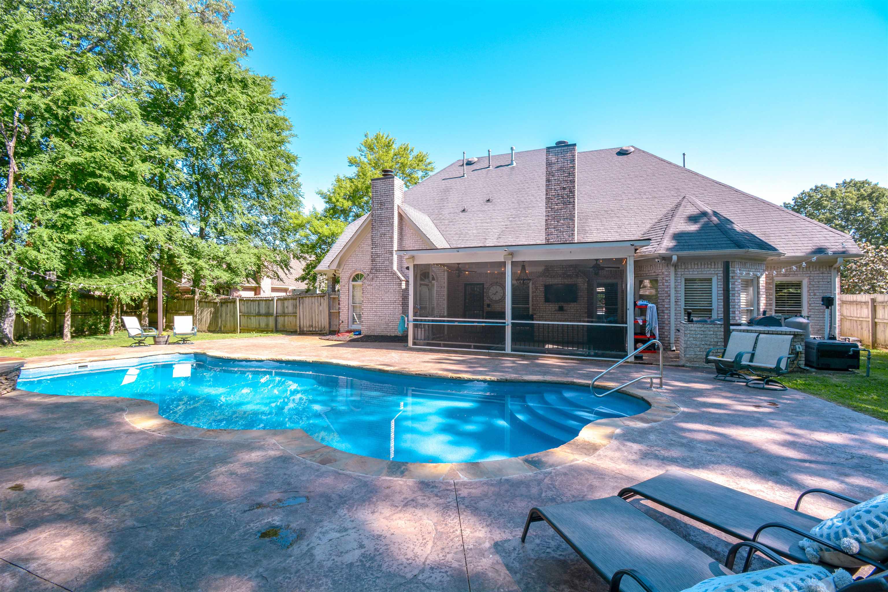 a view of a house with swimming pool and sitting area