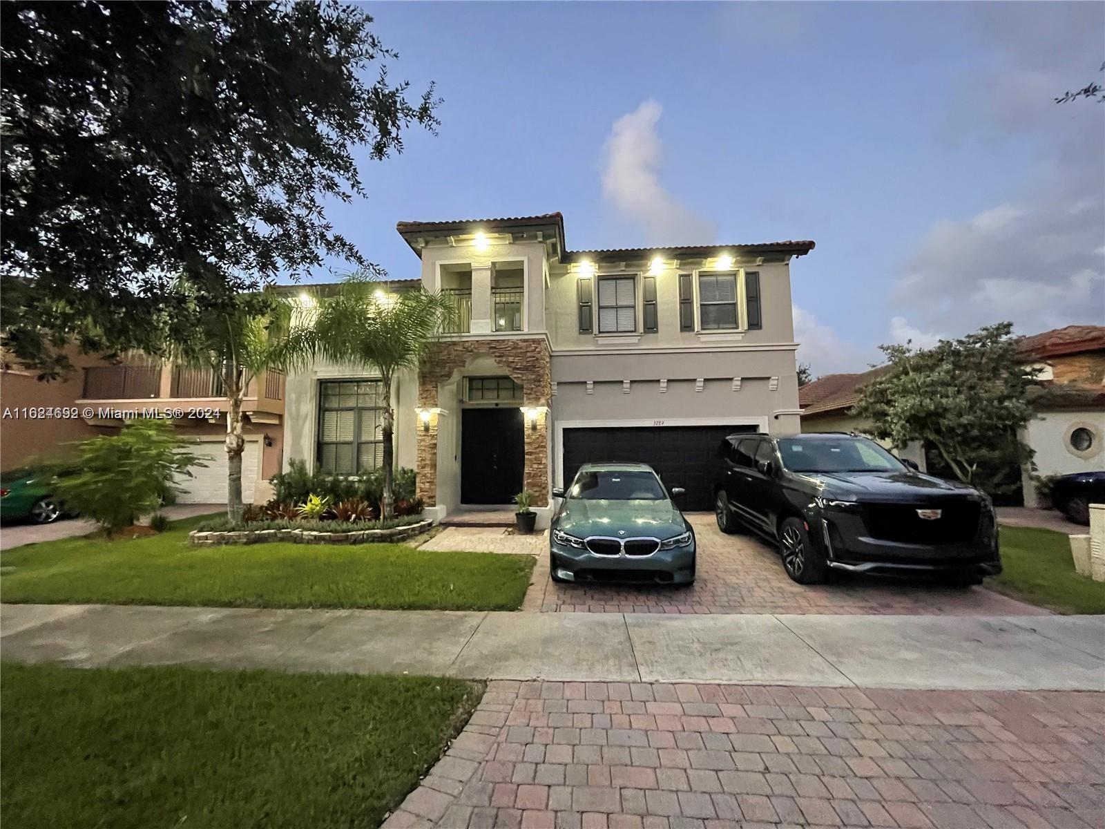 a car parked in front of a brick house