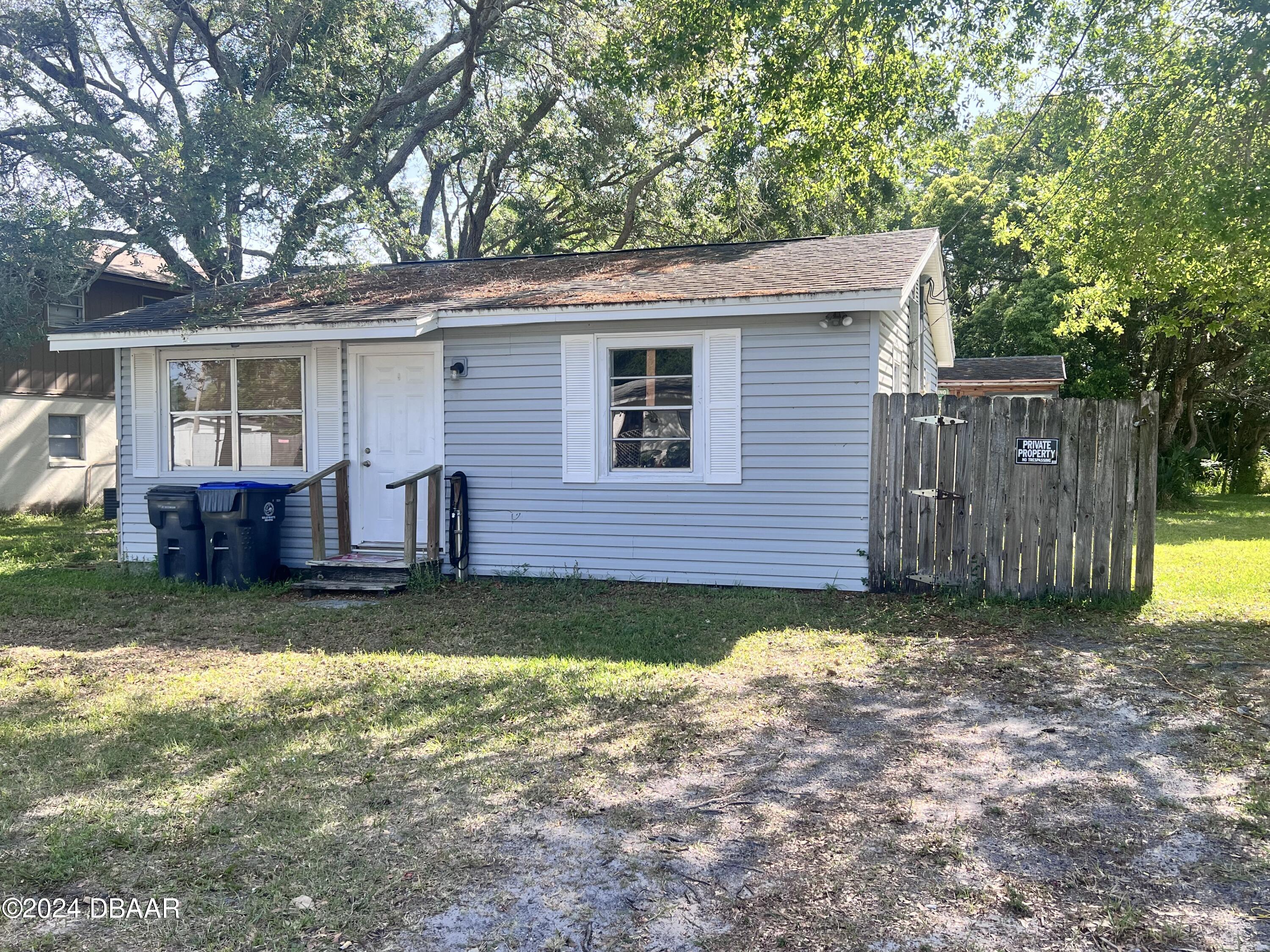 a view of a house with a yard and sitting area