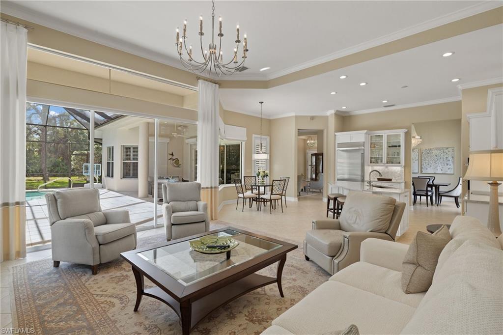 a living room with furniture and a chandelier