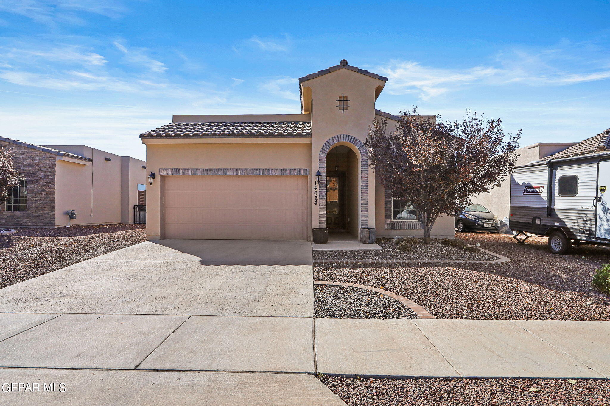 a front view of a house with parking space