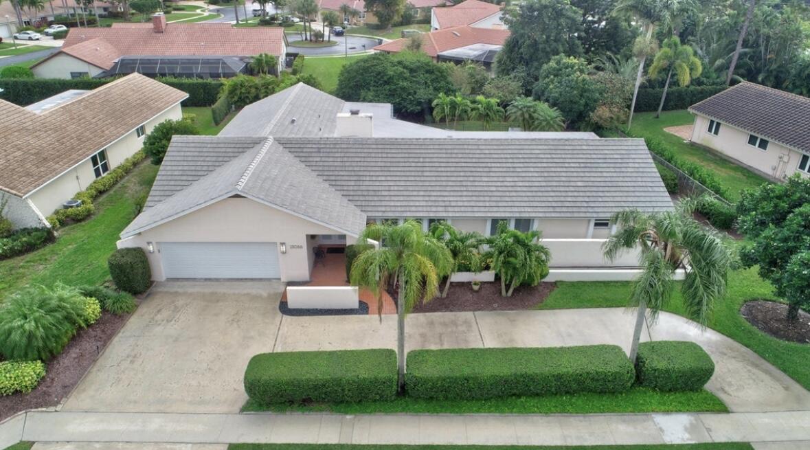 a aerial view of a house with palm trees