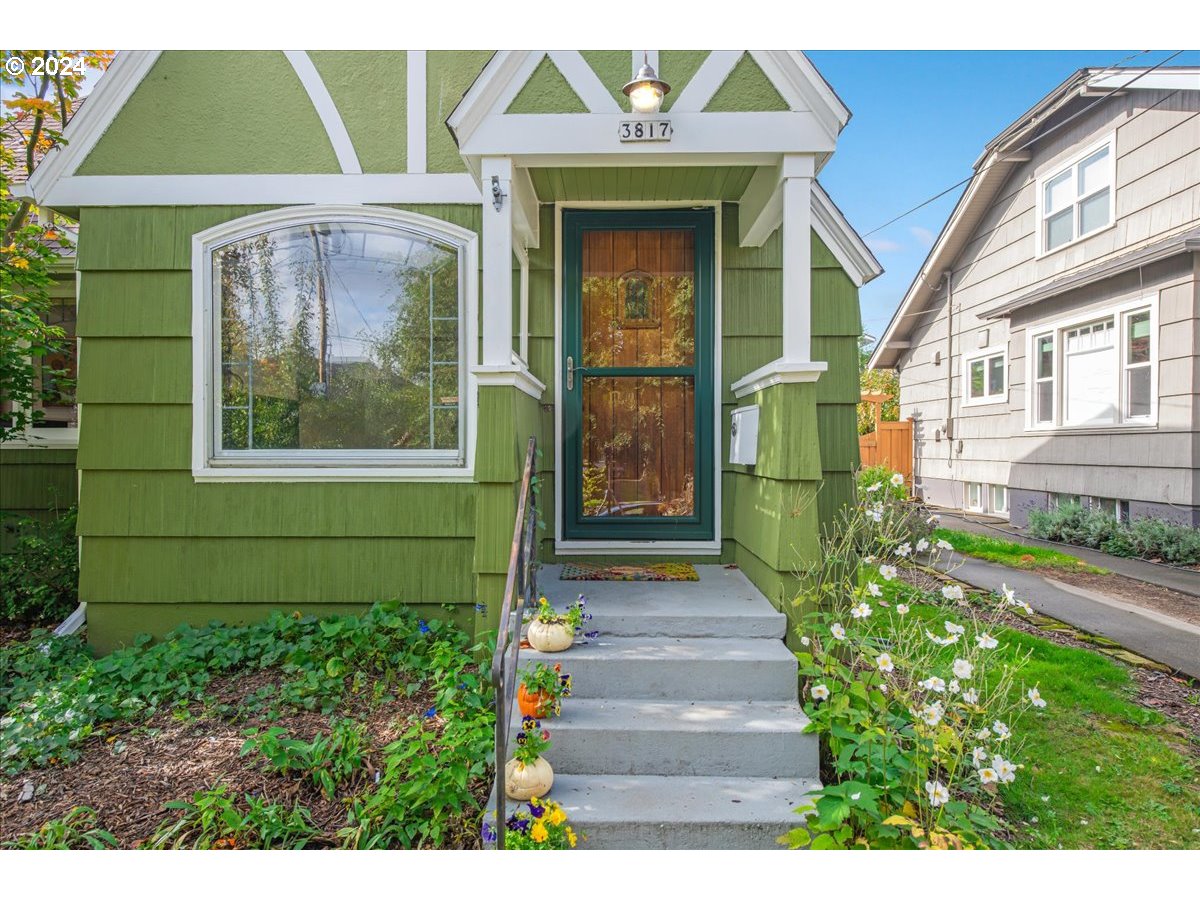 a front view of a house with a garden