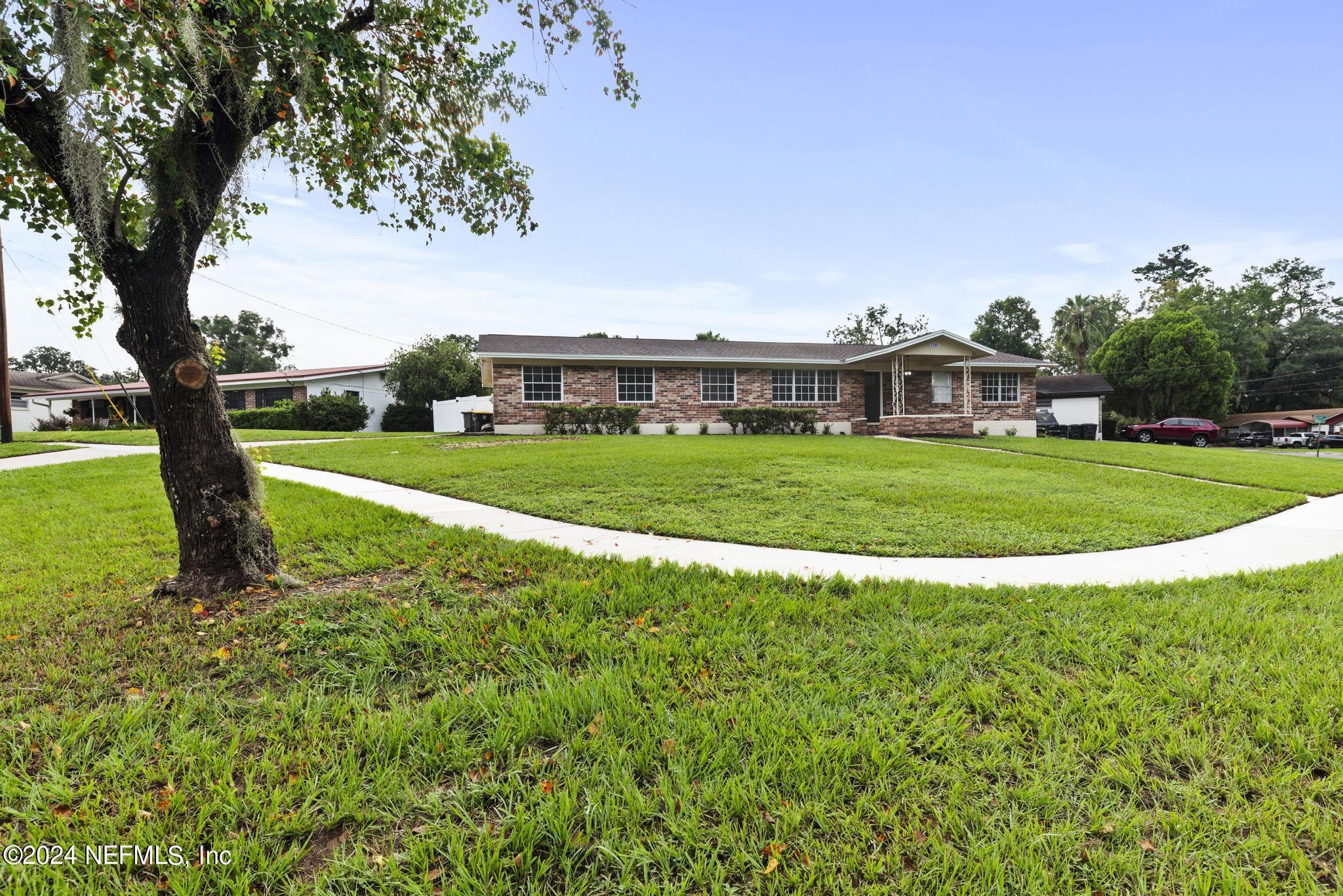 a view of a big yard with a big yard and large trees