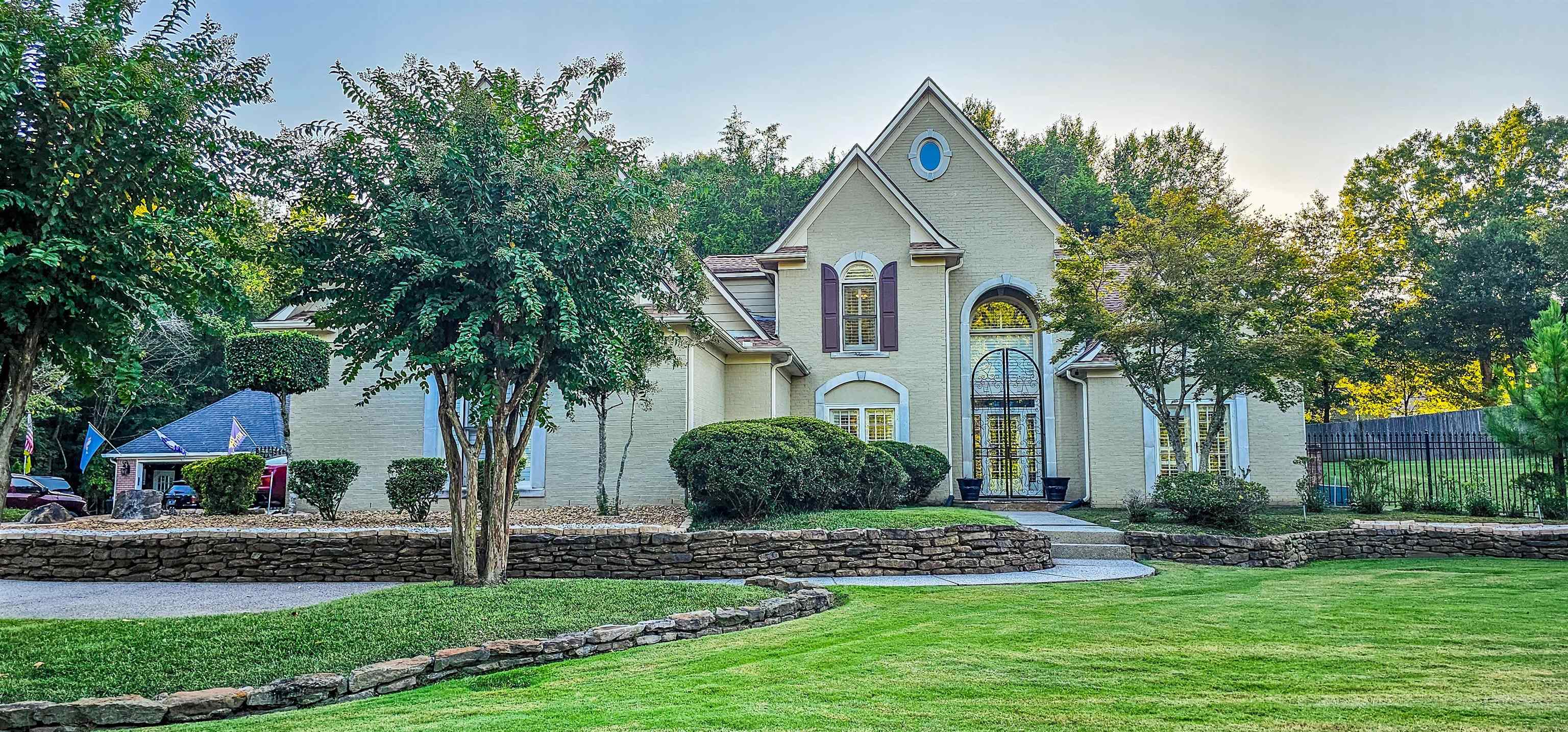 a front view of a house with garden