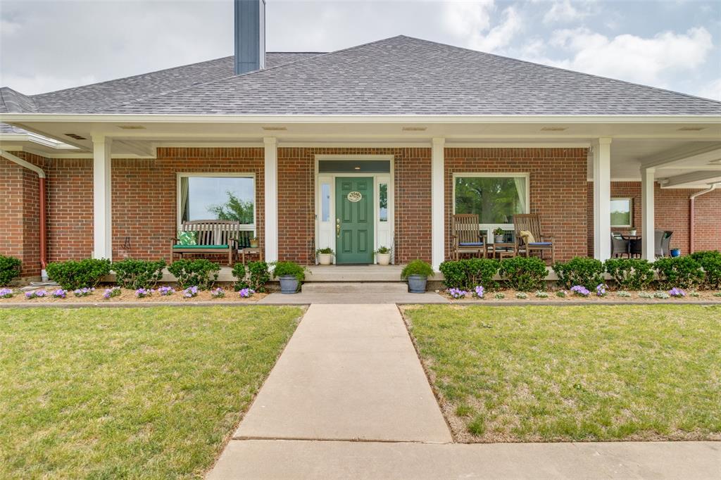 a front view of house and yard with green space